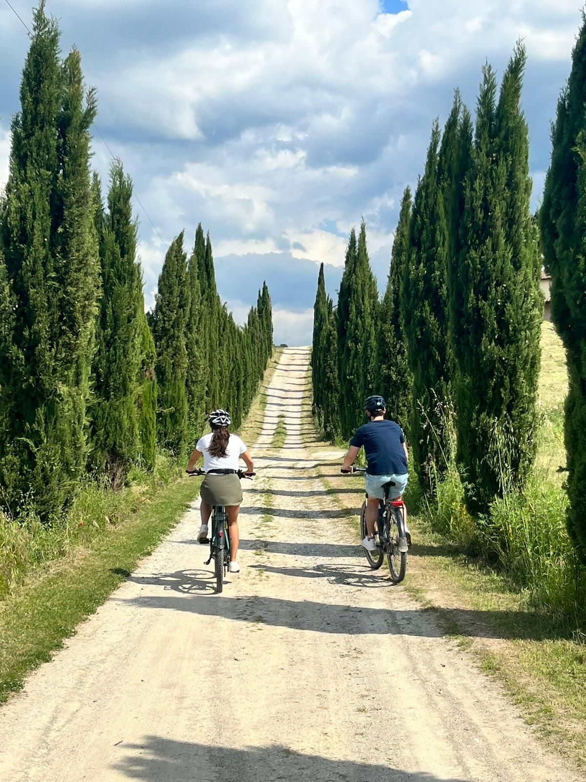 Cycling through cypress-lined roads in Tuscany